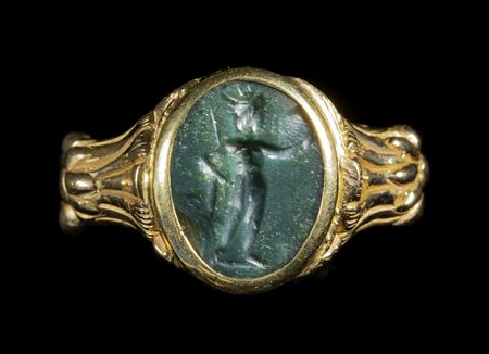 A ROMAN GREEN JASPER INTAGLIO SET IN A GOLD RING. HELIOS. 