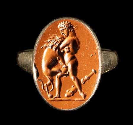 A ROMAN RED JASPER INTAGLIO SET IN A GOLD RING. HERCULES FIGHTING THE NEMEAN LION. 