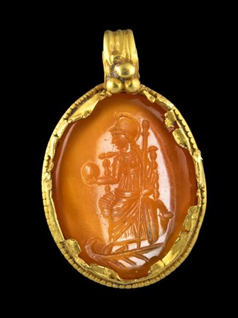 A LATE ROMAN GOLD PENDANT SET WITH A CARNELIAN INTAGLIO. SEATED PERSONIFICATION OF CONSTANTINOPLE.