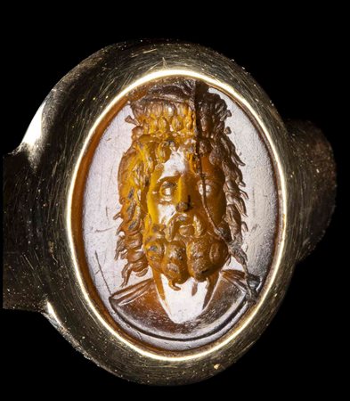 A ROMAN SARD INTAGLIO SET IN A LATER GOLD RING. BUST OF ZEUS SERAPIS. 