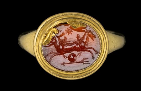 A ROMAN CARNELIAN INTAGLIO SET IN A MODERN GOLD RING. ALLEGORICAL EMBLEMA WITH TWO SEAGOATS. 
