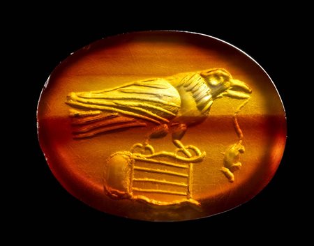 A ROMAN CARNELIAN AGATE INTAGLIO. BIRD ON A LYRE WITH A MOUSE ON ITS BEACK.