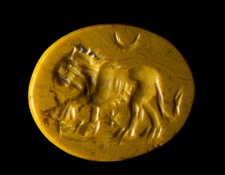A ROMAN YELLOW JASPER INTAGLIO. LION WITH ASTROLOGICAL ATTRIBUTES. 