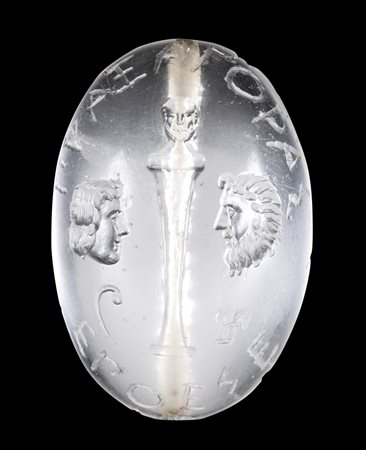 A LARGE POSTCLASSICAL ROCK CRYSTAL INTAGLIO. HERM WITH TWO MASKS AND AN INSCRIPTION. 