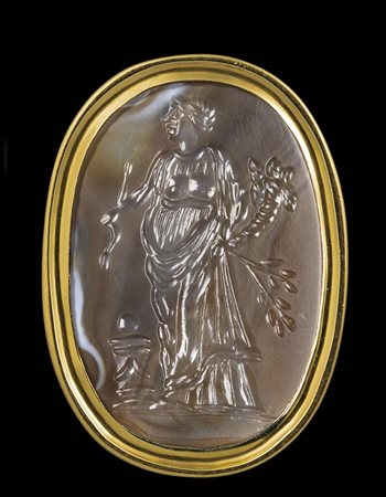 A LARGE AGATE INTAGLIO SET IN A GOLD RING. ALLEGORICAL FIGURE. 