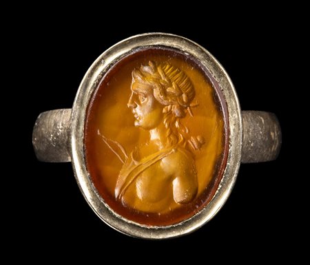 A CARNELIAN INTAGLIO SET IN A GOLD RING. BUST OF APOLLO. 