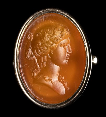 A NEOCLASSICAL CARNELIAN INTAGLIO SET IN A GOLD RING. BUST OF DIONYSOS.