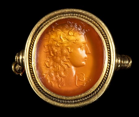 A FINE CARNELIAN INTAGLIO SET IN A GOLD RING. BUST OF MEDUSA. 
