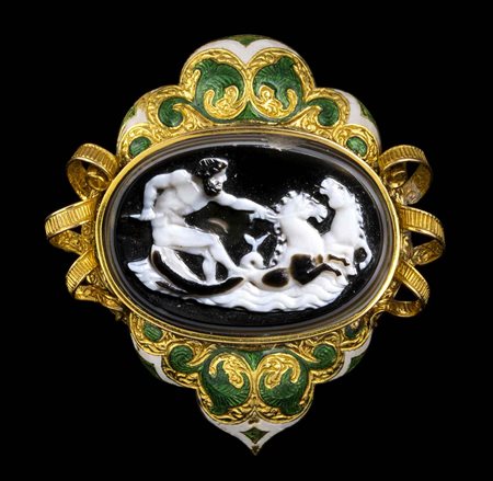 A LARGE AGATE ONYX CAMEO SET IN A GOLD ENAMELED BROOCH. POSEIDON WITH THE SEAHORSES. 