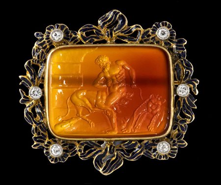 A LARGE CARNELIAN INTAGLIO SET IN GOLD ENAMELED BROOCH WITH DIAMONDS. HERCULES SECURING CERBERUS. 