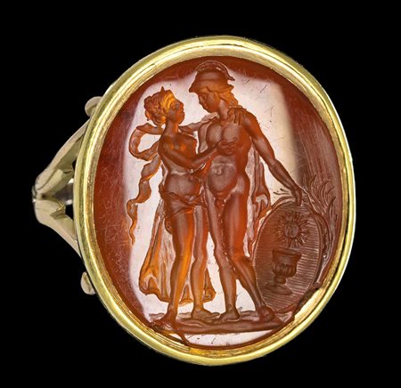 A LARGE CARNELIAN INTAGLIO SET IN A LATER GOLD RING. ALLEGORICAL SCENE. 