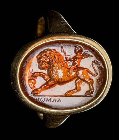 A FINE NEOCLASSICAL SIGNED CARNELIAN INTAGLIO SET IN A GOLD RING. EROS RIDING A LION. 