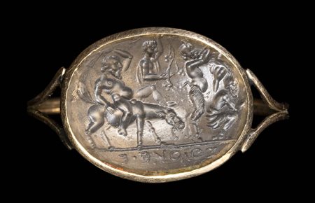 A GRAND TOUR GLASS IMPRESSION SET IN A GOLD RING. DYONISIAC PROCESSION WITH DRUNK SILENUS. 