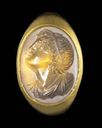 A POSTCLASSICAL CHALCEDONY INTAGLIO SET IN A GOLD RING. BUSTH OF A YOUTH.