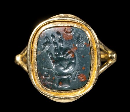 A GRAND TOUR BLOODSTONE MAGICAL ENGRAVED SEAL  SET IN A LATER GOLD RING. HAND USED IN THE WORSHIP OF SABAZIUS WITH ASTROLOGICAL ATTRIBUTES. 