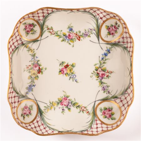 Piccolo vassoio quadrato in porcellana Sevres con decoro a treillage alternato da riserve con mazzetti floreali di rose unite da ghirlande.    