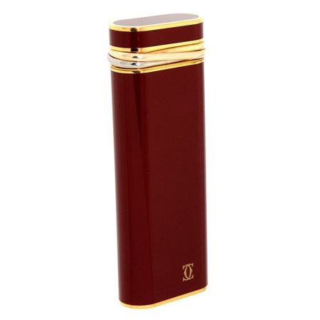 CARTIER Accendino firmato "Cartier", laminato in oro giallo con smalto rosso....