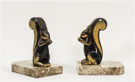 COPPIA DI FERMALIBRI IN METALLO PATINATO - PAIR OF PATINATED METAL BOOKENDS...