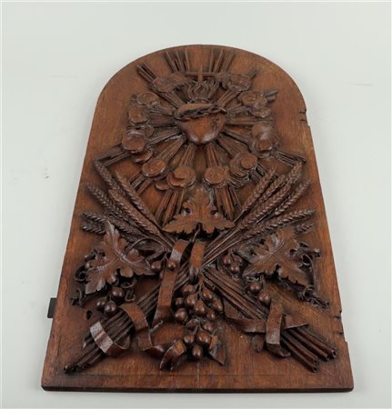 Oak door with a representation of the Sacred Heart above ears of corn and...