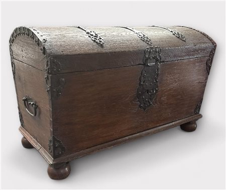 An oak blanket chest on ball feet, with iron fittings and handles. On the...