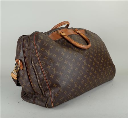 A vintage Louis Vuitton Alizé travel bag with two zipped compartments and a...