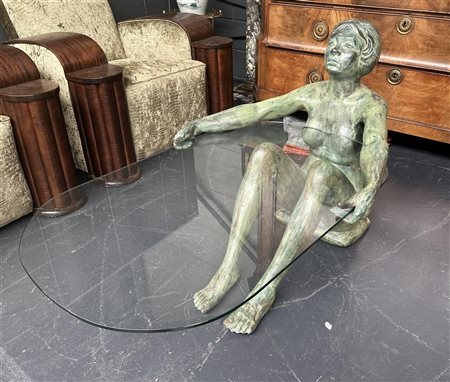 A coffee table in the shape of a seated woman with a hard glass top. (minor...