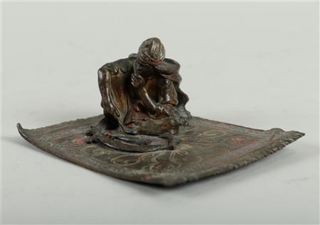 A cold-painted Viennese bronze depicting a seated Arab man with daggers,...