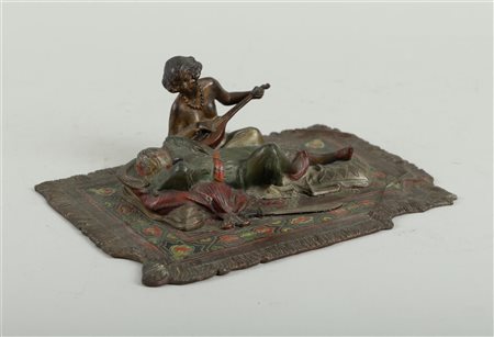 A cold-painted Viennese bronze of a lady playing music with an Arab...