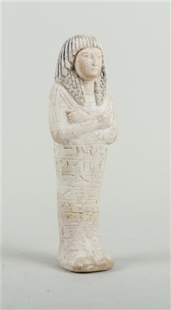 A sandstone Ushabti grave figurine, with remains of polychrome. New Kingdom...