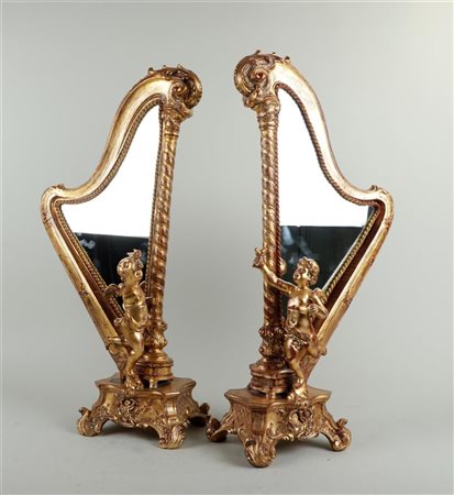 A set of two decorative harp-shaped mantel mirrors with puti. H. 62 cm.