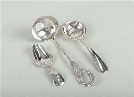 A lot consisting of a silver tea scoop, a wet fruit scoop, and a cream scoop....