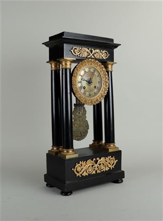 An Empire column clock with fire-gilt mounts. France, circa 1820. H. 50 cm.