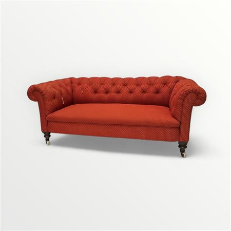 A fabric Chesterfield 2.5 person sofa, with red fabric. The sofa stands on...