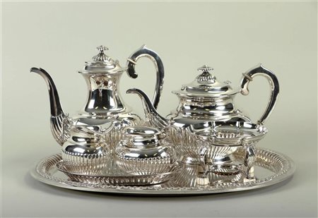 A silver seven-piece tea set consisting of a teapot, a coffeepot, a cream set...