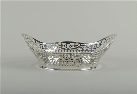 A large, open-cut silver bread basket with pearl rim marked (in the top...