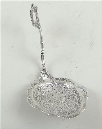 A silver sprinkling spoon with a representation of a courtier before a prince...