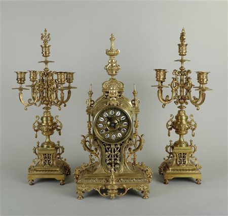 A bronze Garniture de Cheminée, timepiece addressed 'France & Chastant'....