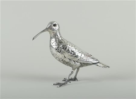 A silver table piece in the shape of a bird (snipe). One glass eye missing....