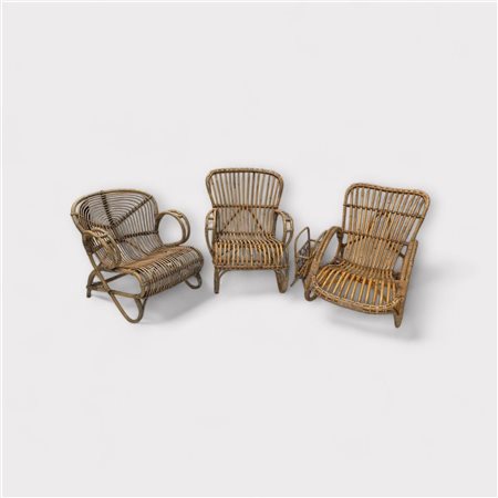 A lot consisting of (3) vintage rattan chairs, and a matching magazine rack,...