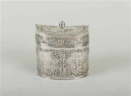 A silver box with embossed representations of a mill on a canal, a...