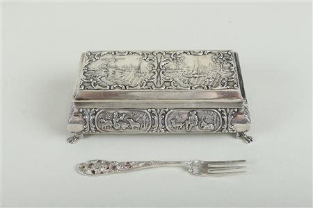 A silver spoon box with embossed representations of a mill on a canal, a...