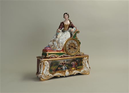 A porcelain mantel clock depicting a seated lady and a classical scene of two...