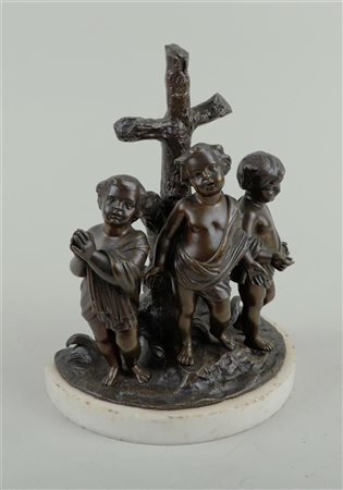 A bronze sculpture of putti at a rough wooden cross. France, 19th century. 26...