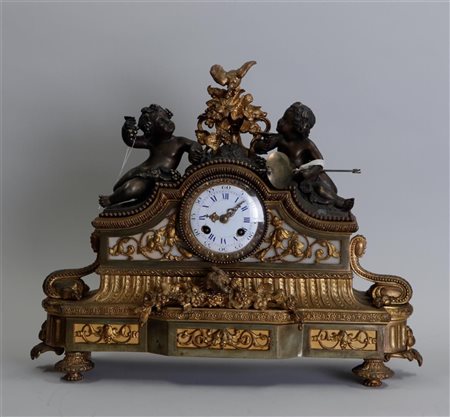 A Louis XVI bronze partly fire-gilt mantel clock decorated with Puto, enamel...