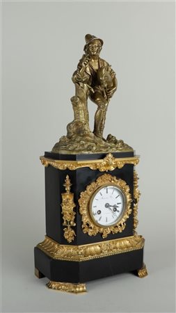 A Louis XVI mantel clock with various gilded accents, on top a bronze figure...