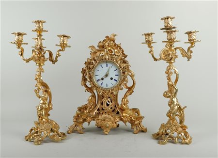 A fire-gilt Garniture de Cheminée in Rococo style, pendulum decorated with...