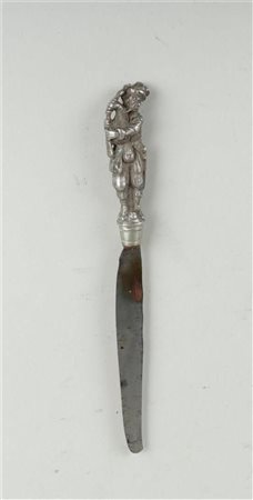 A knife with a copper handle depicting a bagpipe player, blade stamped...