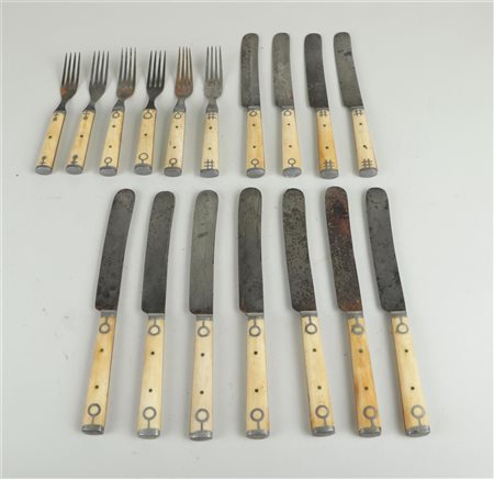 A cutlery set consisting of forks and knives with bone handles, circa 1900.