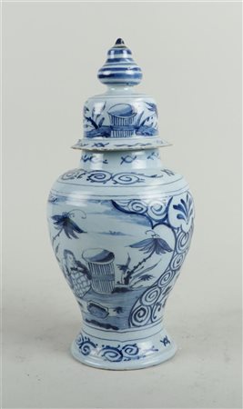 An earthenware covered vase with a decoration of a figure in a garden. Delft,...