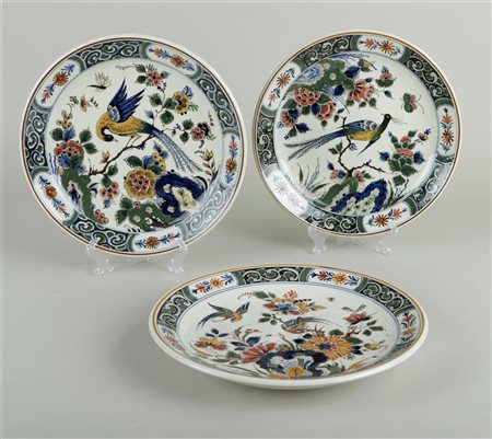 A set of three polychrome painted earthenware plates with decoration of...